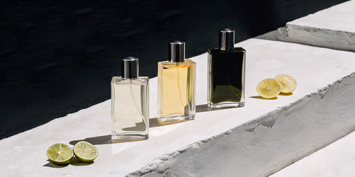 A display of the best citrus colognes for men with fresh lemon and lime.
